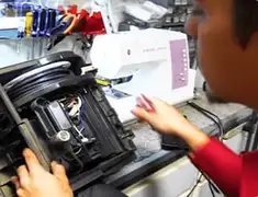 Vacuum repair technician servicing internal components on a workbench in Spokane, WA