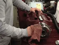 Vacuum repair technician cleaning and servicing a vacuum motor in Spokane, WA